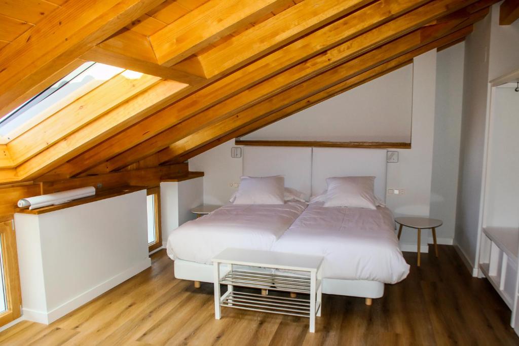 A bed or beds in a room at Apartamentos Mundaka Surf Camp