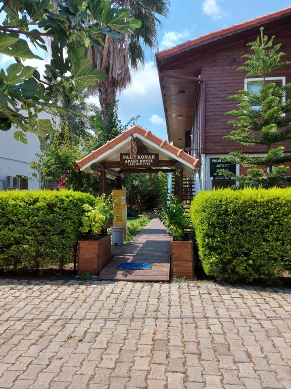 a walkway leading to the entrance to a building at Palm Konak Hotel in Cıralı