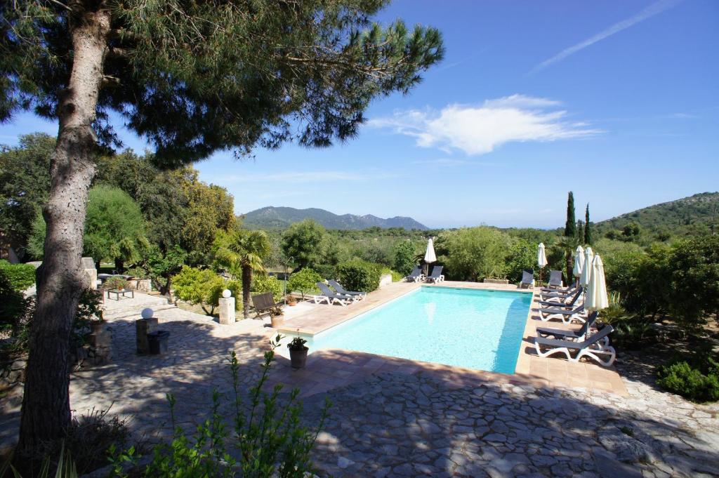 a swimming pool with a view of a resort at El Encinar de Arta in Artá