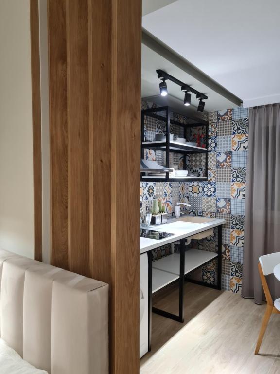 a kitchen with a table in a room at TAM Center Studio Apartment Next To Blloku No1 in Tirana