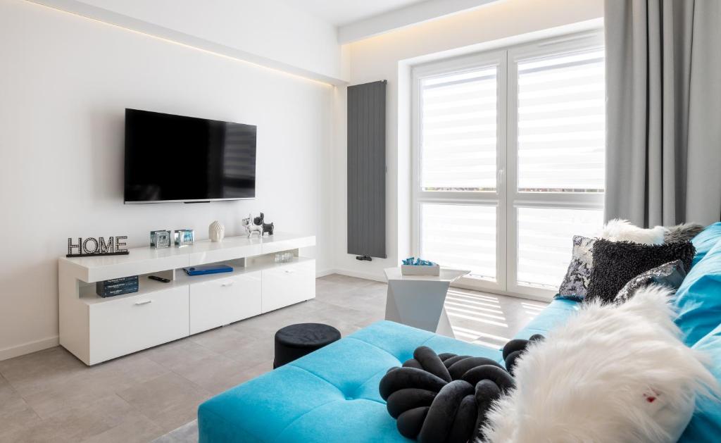 Televízia a/alebo spoločenská miestnosť v ubytovaní Leo Apartament Delux