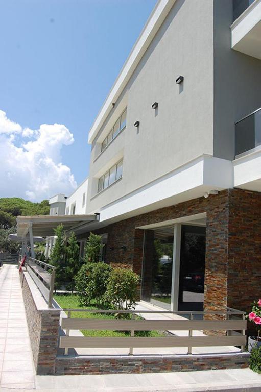 a building with a person walking in front of it at On Board Luxury Studios in Sarti
