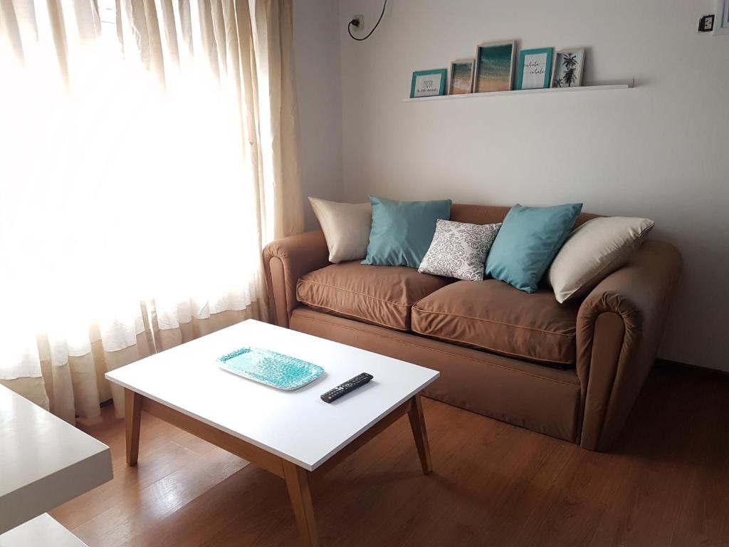 a living room with a couch and a coffee table at NidoAparte Departamento Lujan Centro in Luján