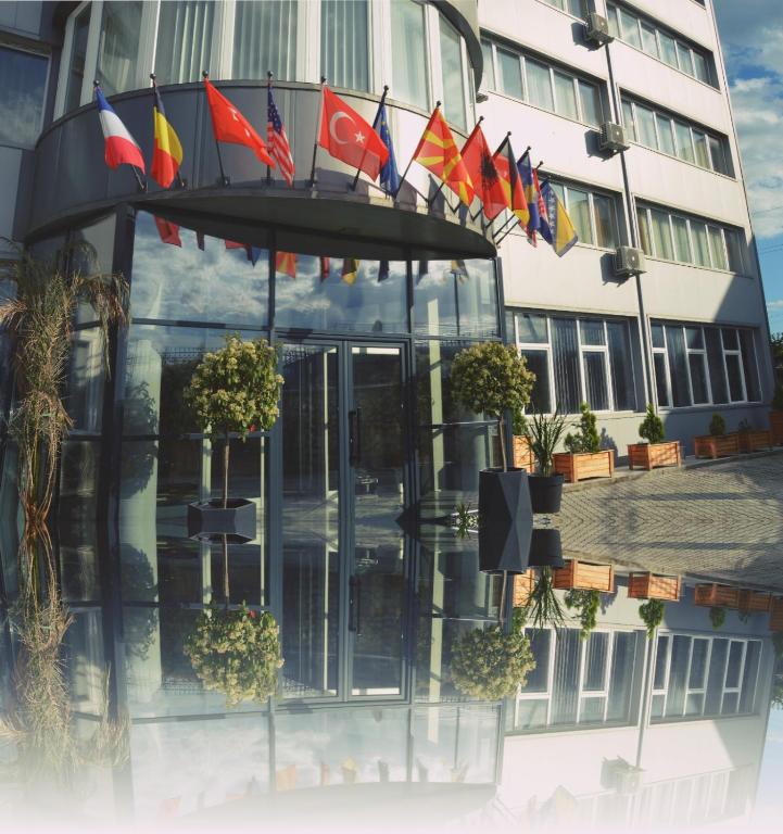 a group of flags on the side of a building at Hotel & Resort Bon Bon in Skopje