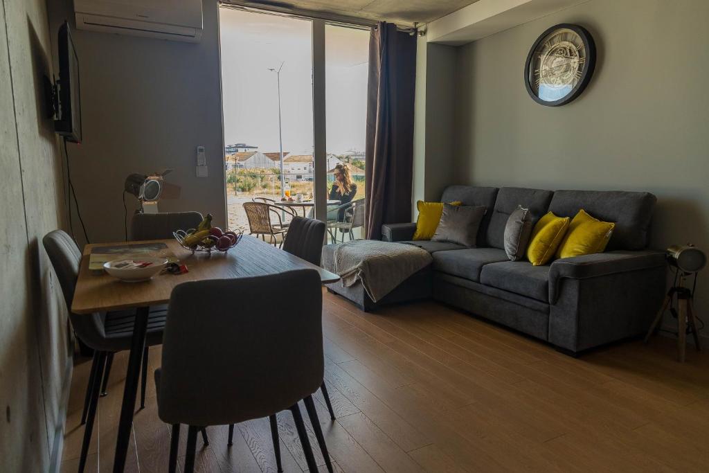 a living room with a couch and a table at Sal, Terra e Mar in Aveiro