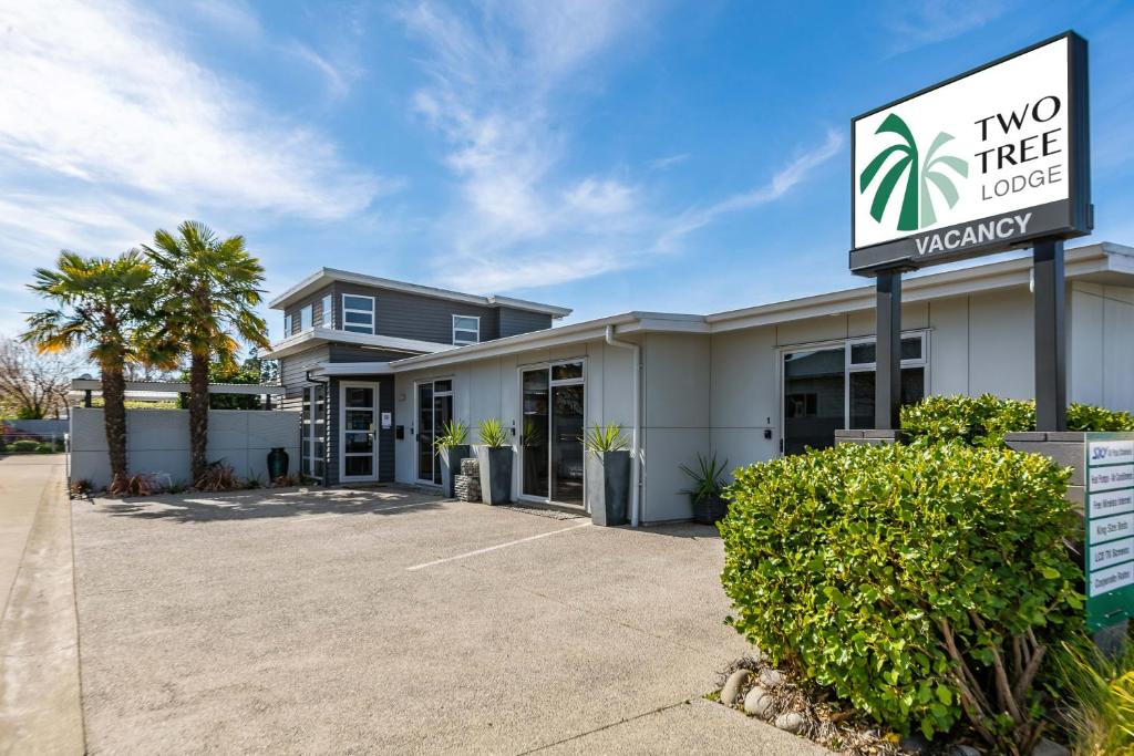 a two tree lodge sign in front of a building at Two Tree Lodge in Blenheim