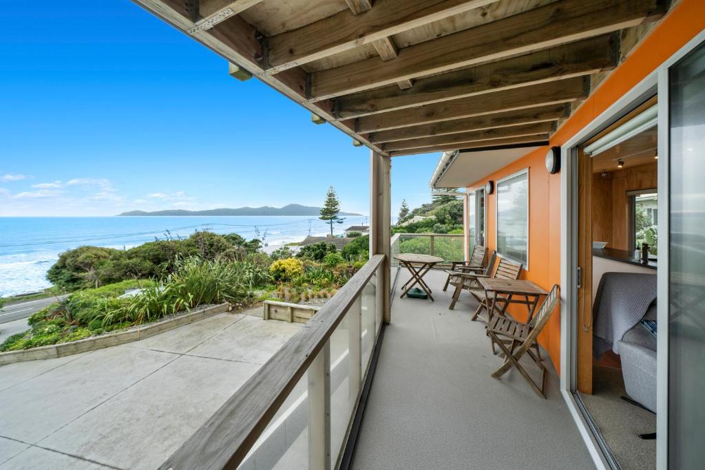 a balcony with a view of the ocean at Rippling Waves Lookout - Raumati South Home in Raumati South
