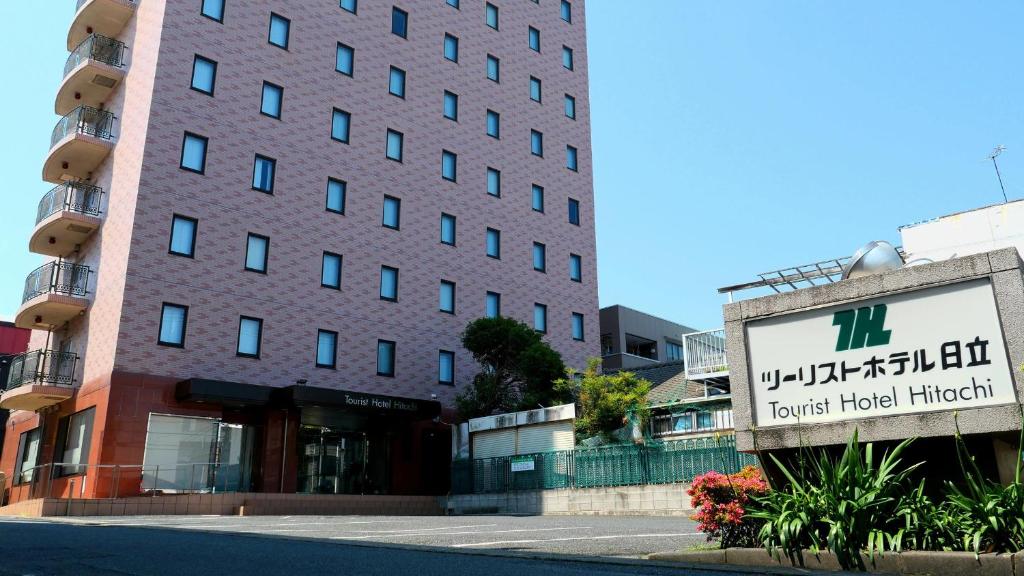 a large building with a sign in front of it at Tourist Hotel Hitachi in Hitachi
