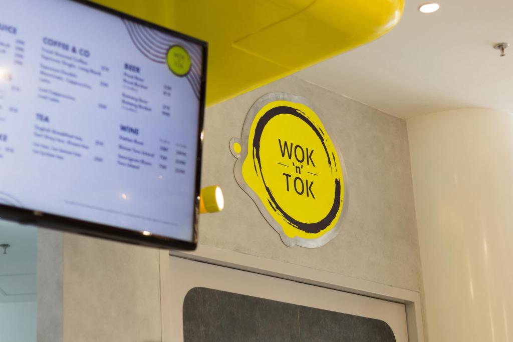 a sign on the wall of a restaurant with the words work top at YELLO Hotel Kuta Beachwalk Bali in Kuta
