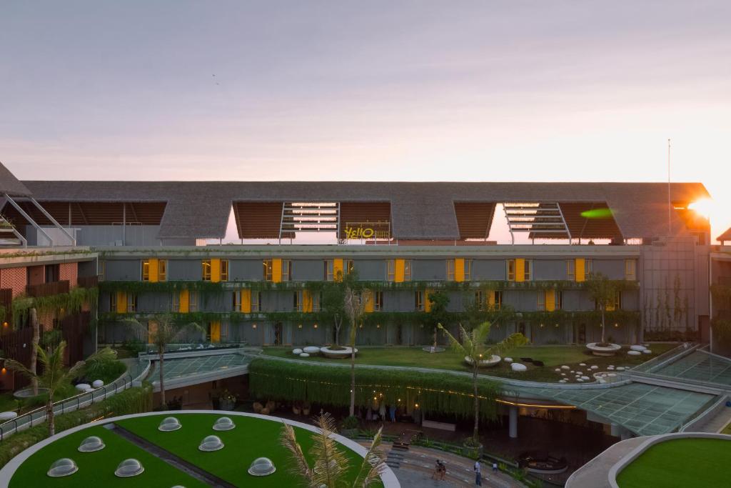 an exterior view of a building with a courtyard at YELLO Hotel Kuta Beachwalk Bali in Kuta