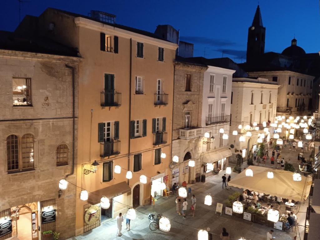 a group of people walking around a street at night at Emperador in Alghero