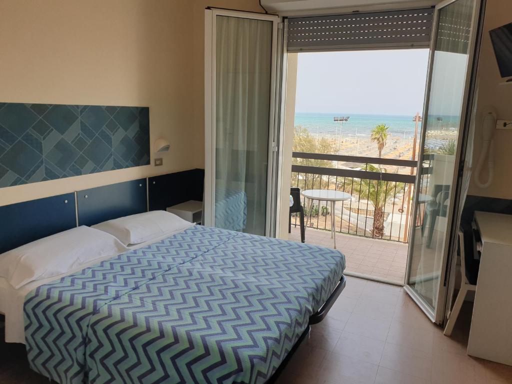 Postel nebo postele na pokoji v ubytování Hotel Giannini