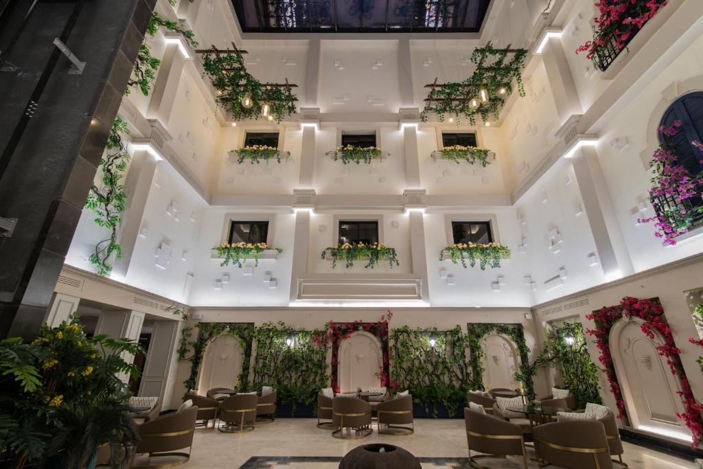 a view of the lobby of a hotel with tables and chairs at Gardino Hotel & Residence in Riyadh
