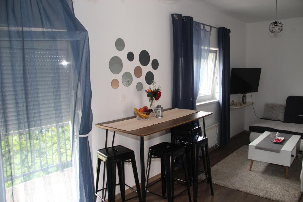 cocina con mesa y taburetes en una habitación en Apartman ANA Livno - biker friendly, en Livno