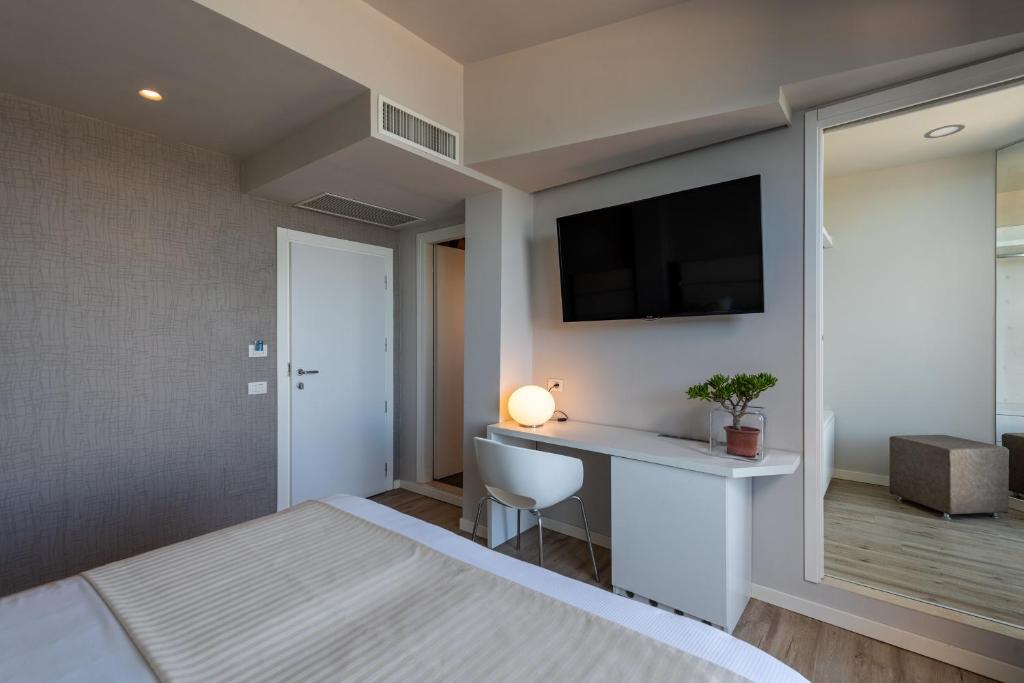 Postel nebo postele na pokoji v ubytování Hotel Commodore