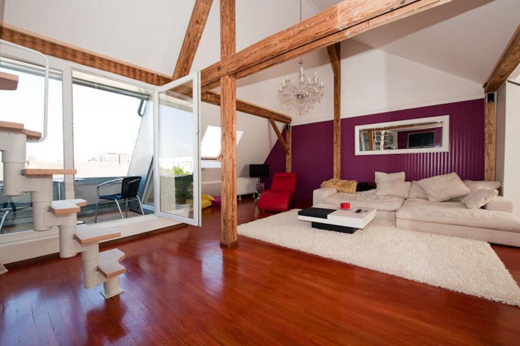 a living room with a couch and a table at City Lux Apartment in der Stadt in Freiburg im Breisgau