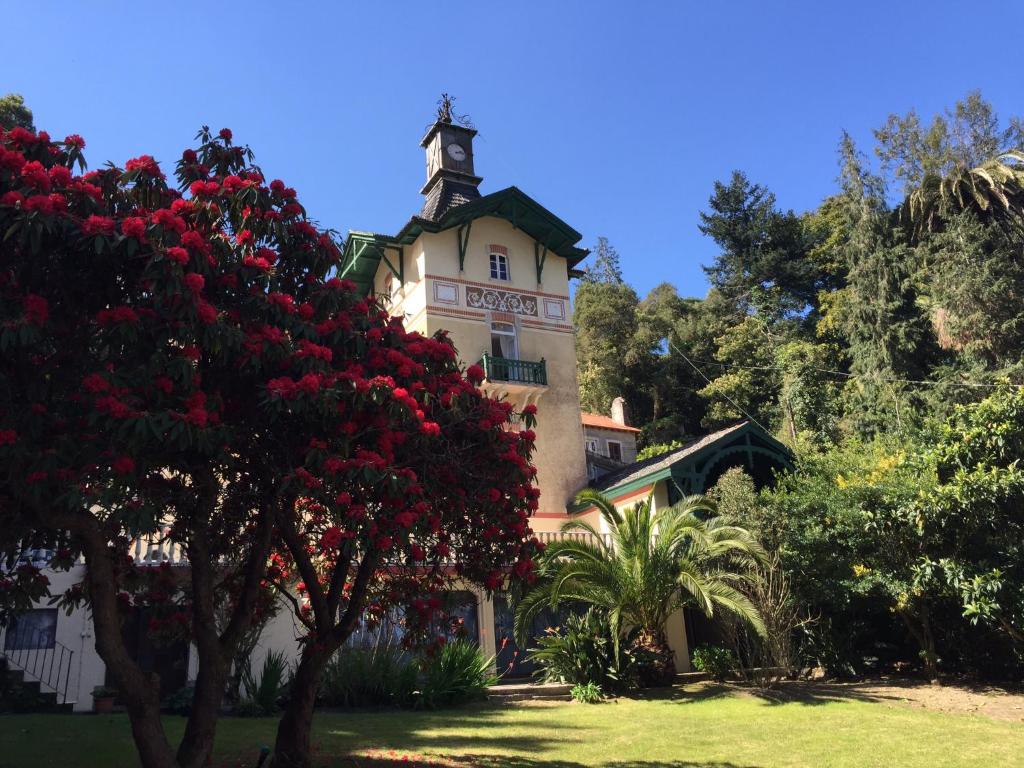 a large building with a clock on the top of it at Chalet Relogio Guesthouse in Sintra