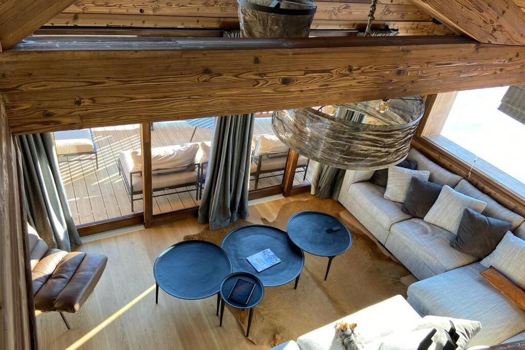 an overhead view of a living room with couches and tables at chalet Cocoa in Hauteluce