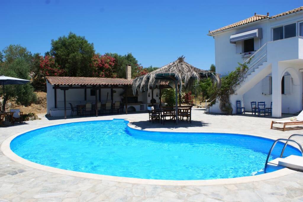 a swimming pool in front of a house at Nona's House in Kalamaki