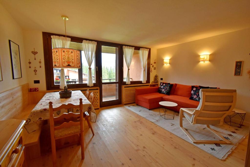 a living room with a couch and a table at RIO FALZE' Wood in Madonna di Campiglio