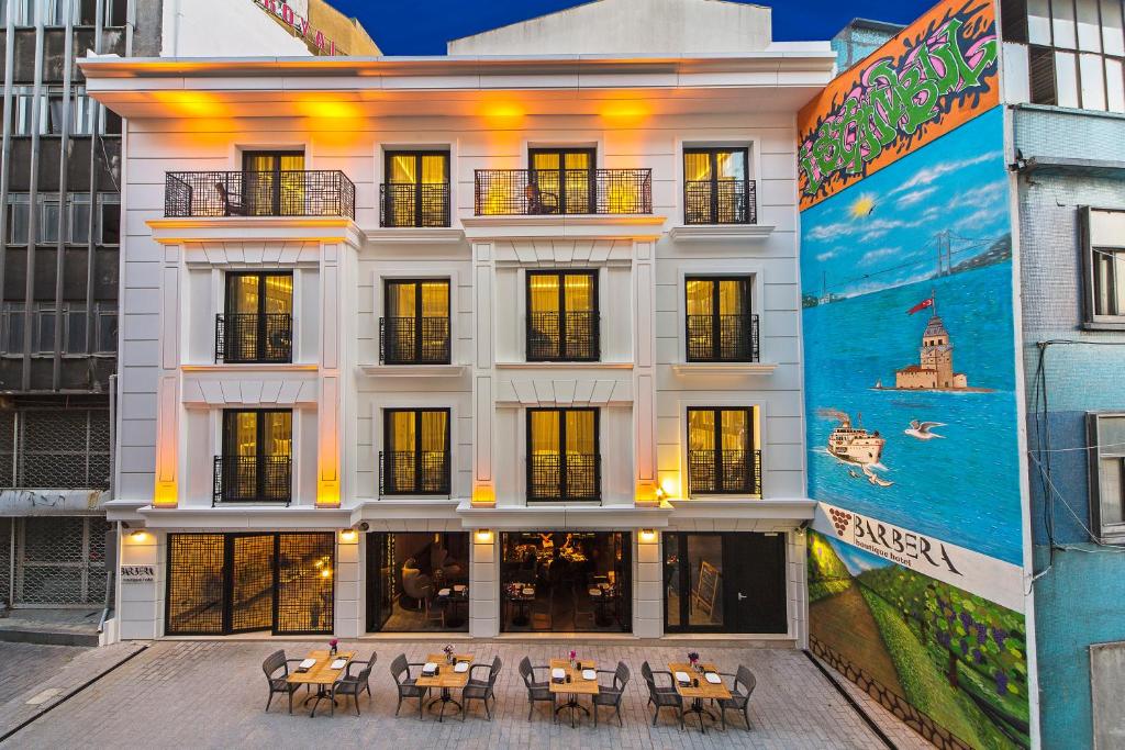a building with tables and chairs in front of it at Barbera Hotel in Istanbul
