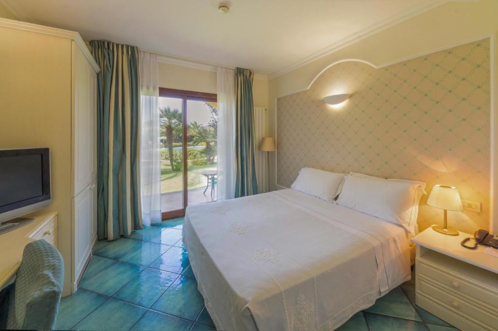 Posteľ alebo postele v izbe v ubytovaní Hotel Santa Gilla