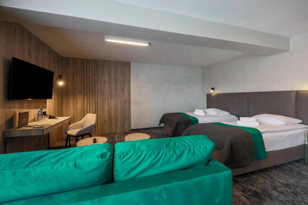 Posteľ alebo postele v izbe v ubytovaní Hotel Pod Jedlami