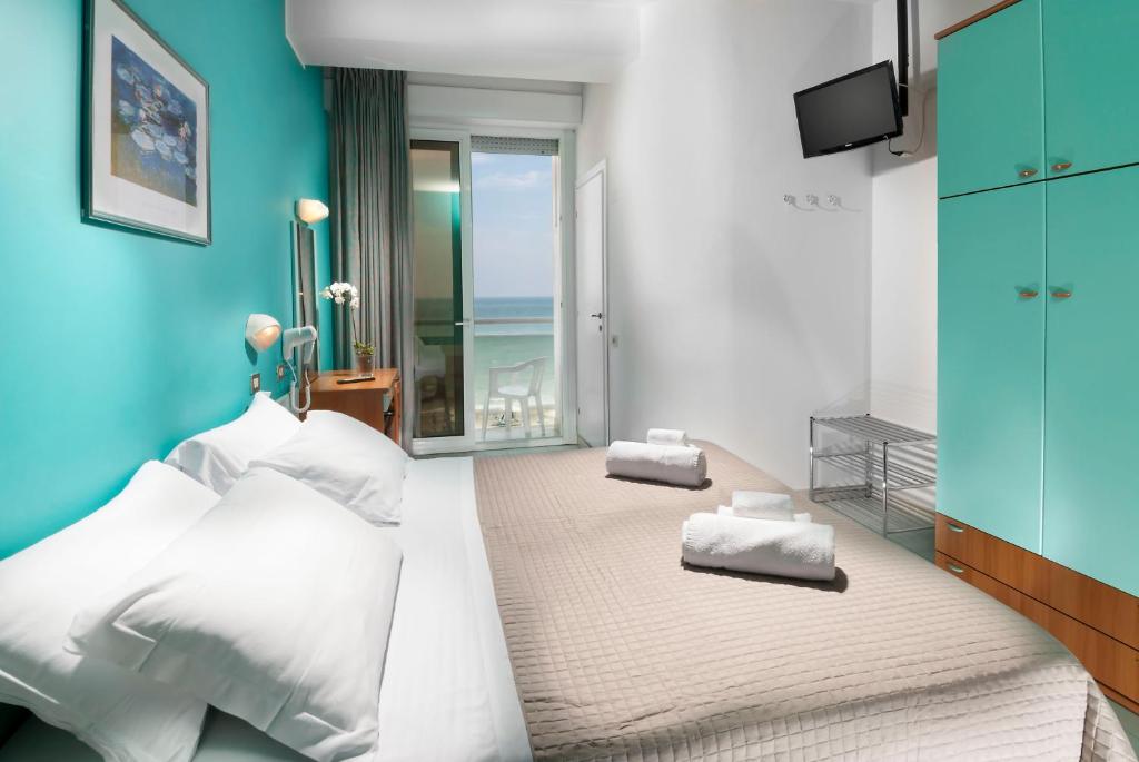 Postel nebo postele na pokoji v ubytování Hotel International direttamente sulla Sabbia