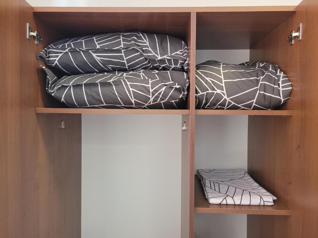 a shelf with two pillows on top at Apartamente Livada in Râmnicu Vâlcea