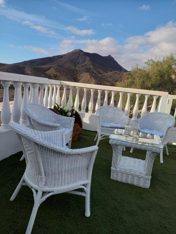 a group of chairs and a table on a balcony at GARABATO in La Pared