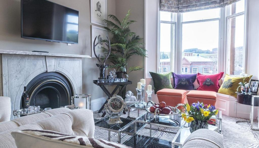 a living room with a couch and a fireplace at Ram Lodge in Moffat