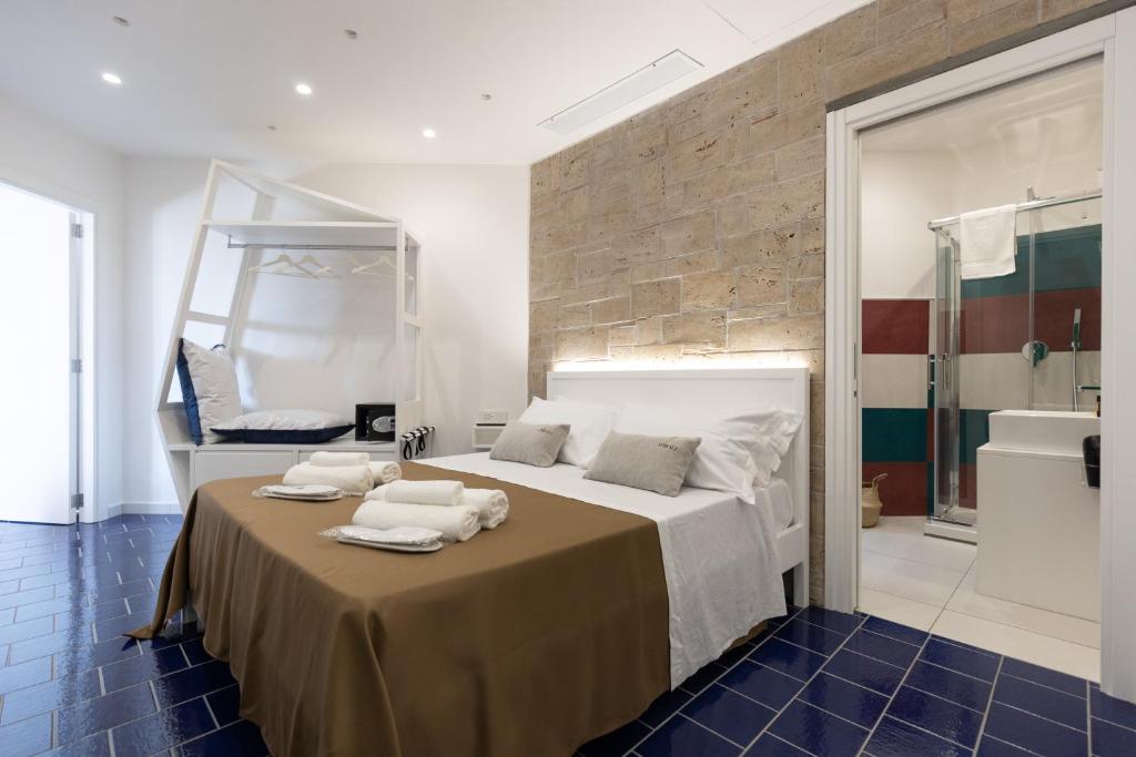 a bedroom with a bed with towels on it at Anreale Rooms Paestum in Paestum