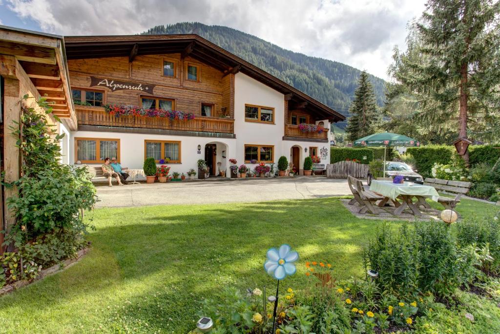 a large building with a lawn in front of it at Alpenruh in Pettneu am Arlberg