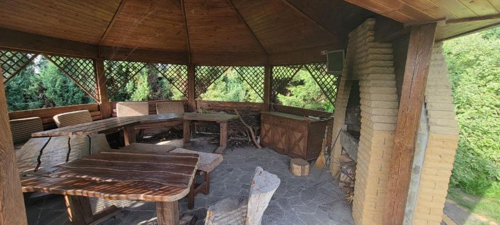 an outdoor dining area of a gazebo with a table and chairs at Трушки34/1 in Trushki