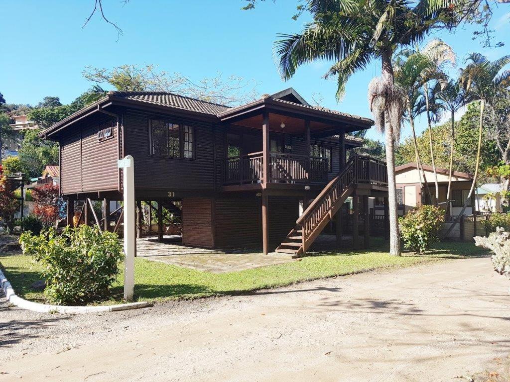 a house with a balcony and a porch at Natures Cabin in Hibberdene