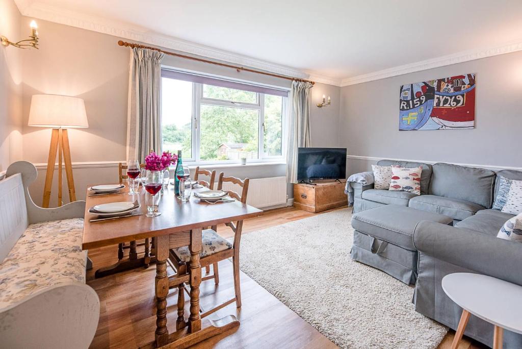 a living room with a couch and a table at Hillside View in Southwold