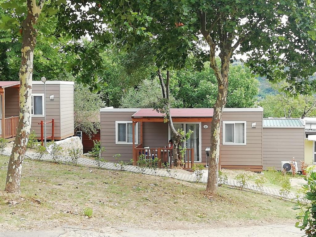 a small house with trees in front of it at hu Firenze Certosa camping in town in Impruneta