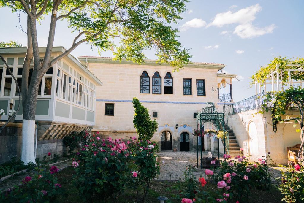 a building with flowers in front of it at Gul Konakları - Sinasos - Special Category in Ürgüp