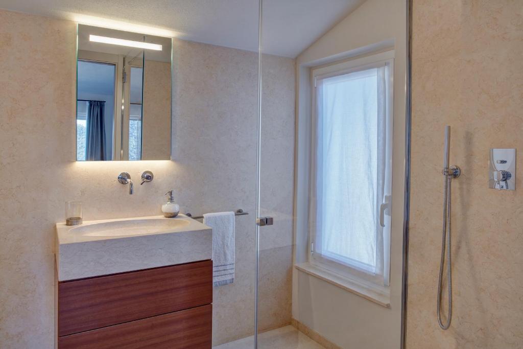 a bathroom with a sink and a glass shower at Il Leccio - Luxury Resort Portofino Monte in Santa Margherita Ligure