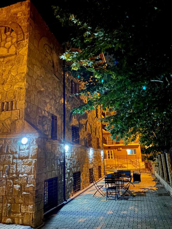 a building with a table and chairs in front of it at night at Vila Sabarel in Eforie Sud