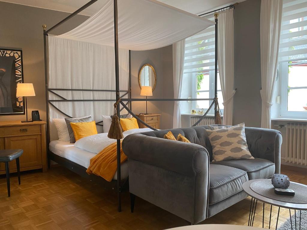 a living room with a couch and a canopy bed at Haus Christine in Traben-Trarbach in Traben-Trarbach