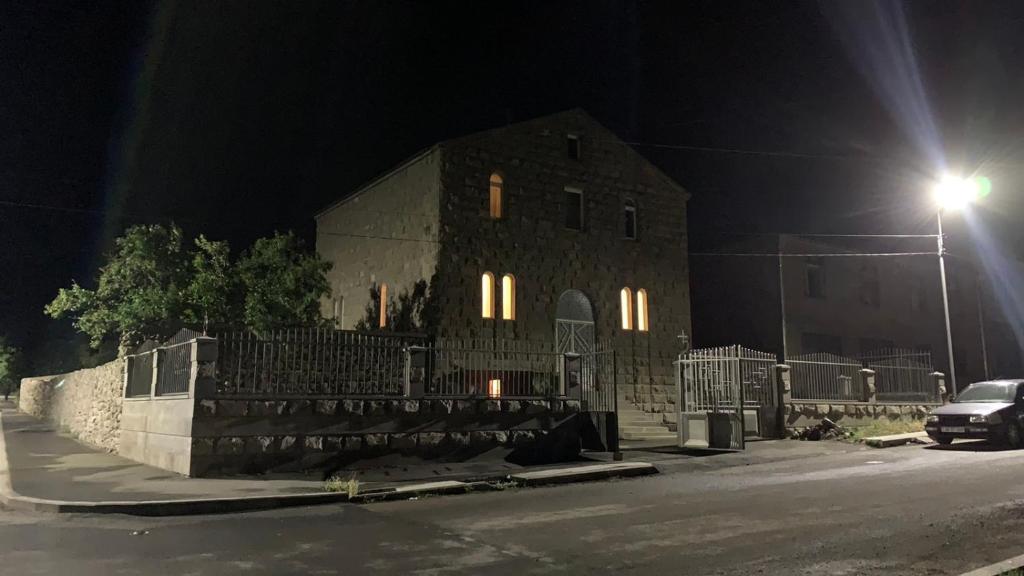 a building with a car parked in front of it at night at MITANE in Sisian