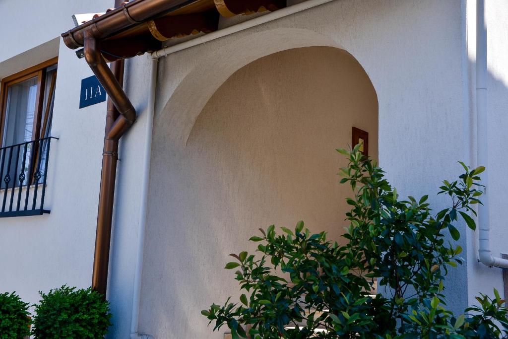 an archway on the side of a building with a tree at Boutique Damiani in Sibiu