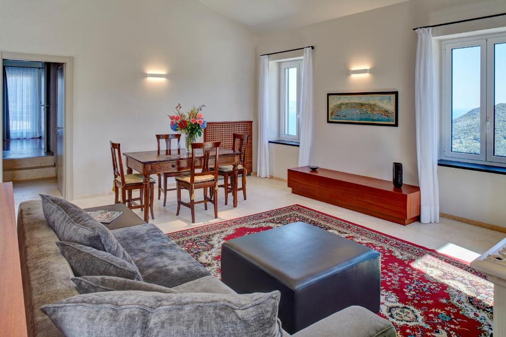 a living room with a couch and a table at Il Leccio - Luxury Resort Portofino Monte in Santa Margherita Ligure