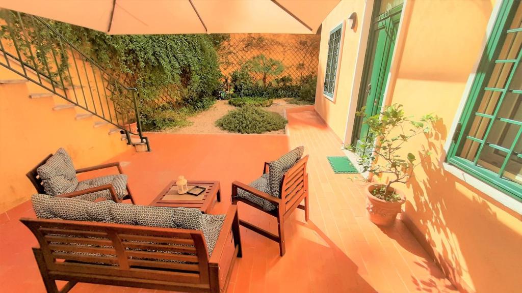 a balcony with two chairs and a table and an umbrella at B&B Five in Rome