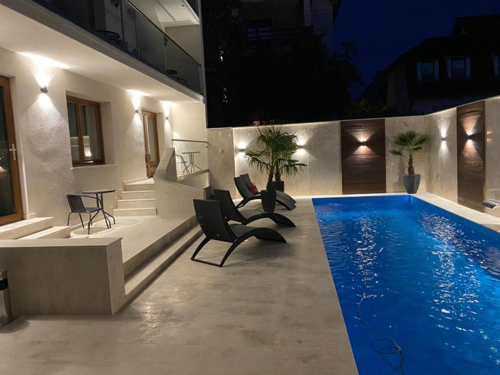 a house with a swimming pool at night at Boutique Damiani in Sibiu