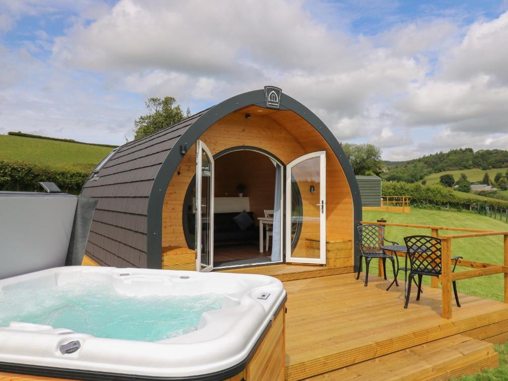 a igloo house with a hot tub on a deck at Seren in Llandrindod Wells