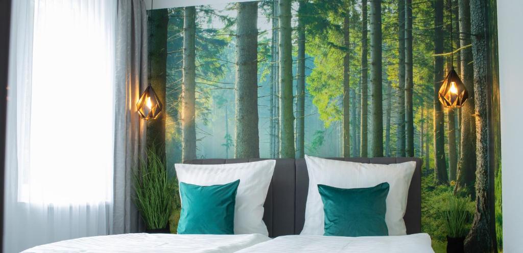 a bedroom with a bed with a forest backdrop at Gästehaus&Pension Pinske in Saalburg-Ebersdorf