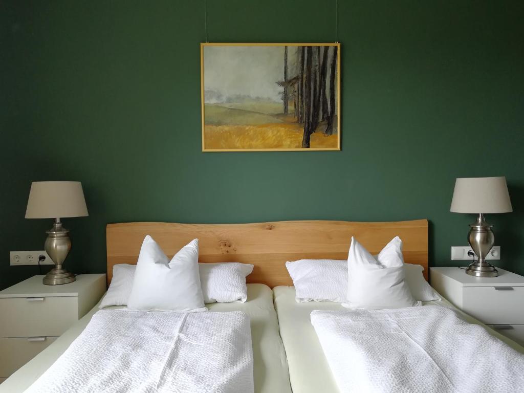 a bedroom with two beds with white pillows at FerienwohnungenAufDemDorf nahe LEGOLAND in Neuburg an der Kammel