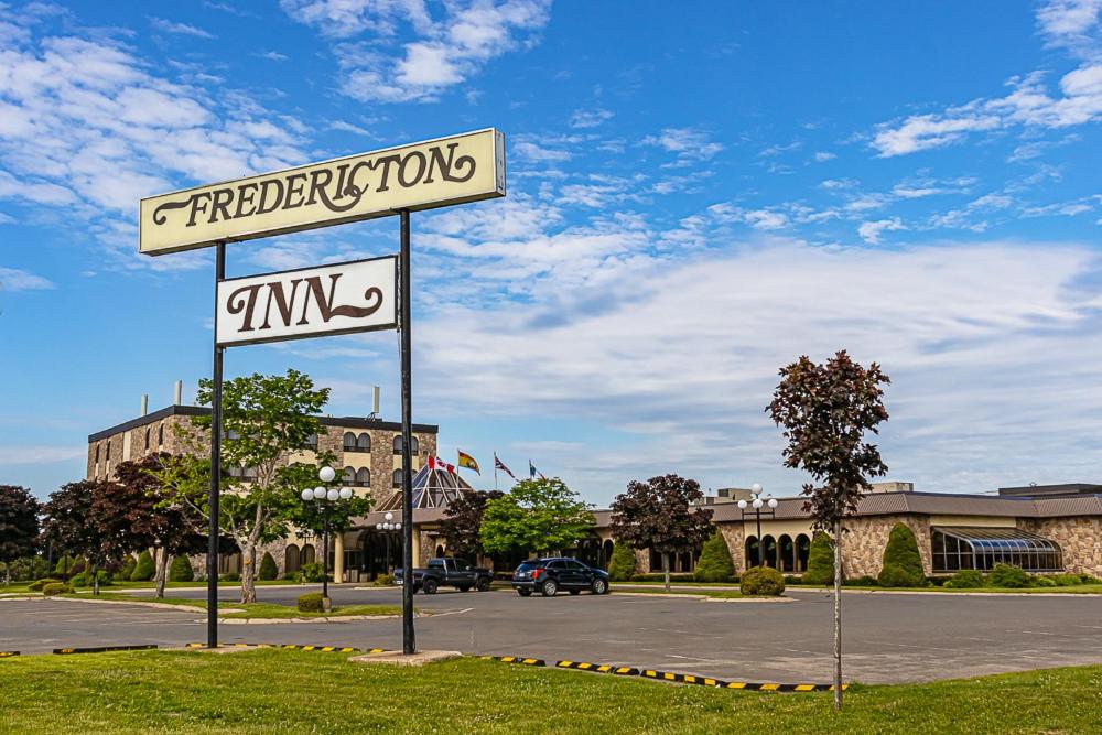 a street sign in the middle of a parking lot at The Fredericton Inn in Fredericton